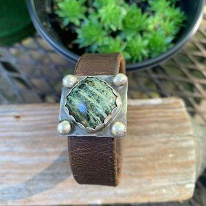 Beautiful concho with green serpentine on old leather